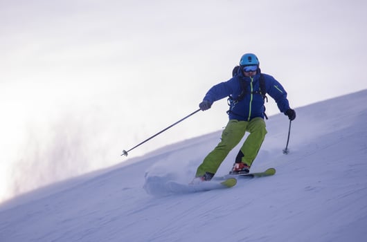Skier having fun while running downhill photo