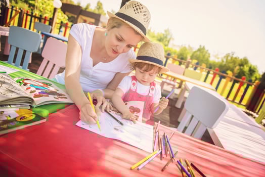 mom and little daughter drawing a colorful pictures photo