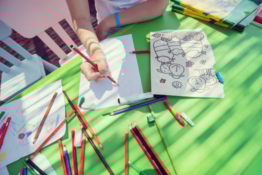 closeup of hands drawing a colorful pictures photo