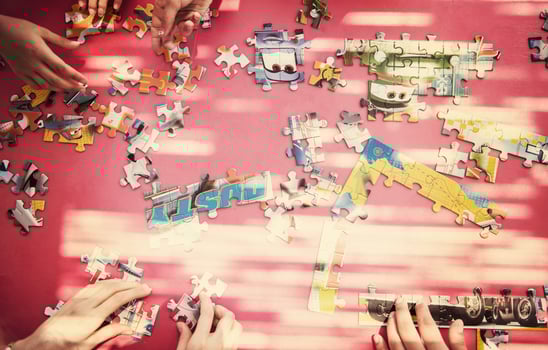 top view of kids hands playing with puzzles photo