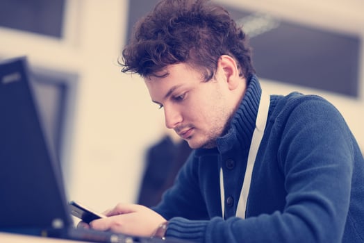 Young casual businessman using smartphone photo