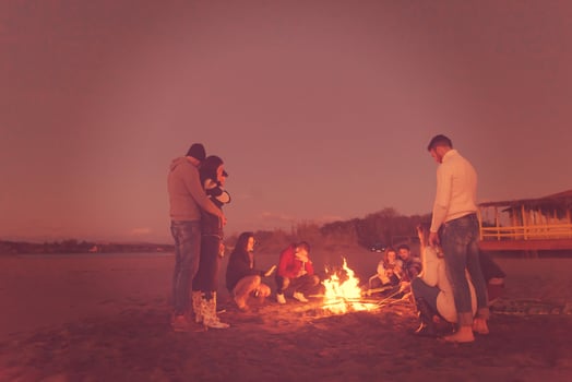 Friends having fun at beach on autumn day photo