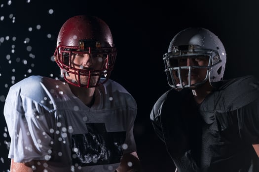 two american football players face to face in silhouette shadow on white background photo