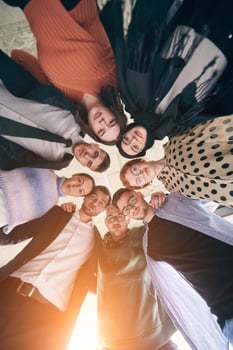 A diverse group of business professionals, embracing each other tightly, symbolizes unity and solidarity photo