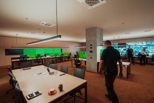 Group of Security data center operators working in a CCTV monitoring room looking on multiple monitors Officers Monitoring Multiple Screens for Suspicious Activities Team working on the System Contr photo