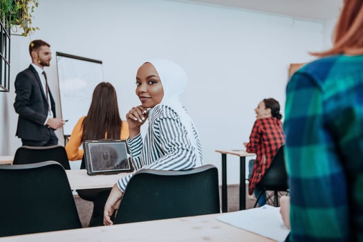 African American Muslim woman listens to a lecture aimed at business training photo
