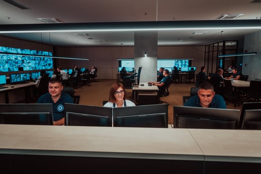 Group of Security data center operators working in a CCTV monitoring room looking on multiple monitors Officers Monitoring Multiple Screens for Suspicious Activities Team working on the System Contr photo