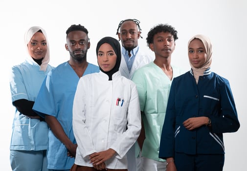 Team or group of a doctor, nurse and medical professional coworkers standing together. Portrait of diverse healthcare workers looking confident. Middle Eastern and African, Muslim medical team. photo