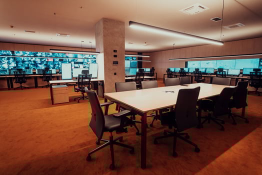 Empty interior of big modern security system control room, workstation with multiple displays, monitoring room with at security data center Empty office, desk, and chairs at a main CCTV security data photo