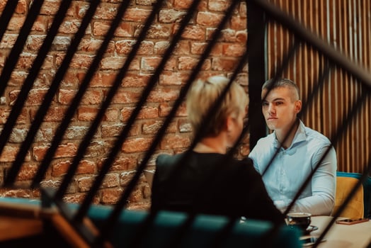 Happy businesspeople smiling cheerfully during a meeting in a coffee shop. Group of successful business professionals working as a team in a multicultural workplace. photo
