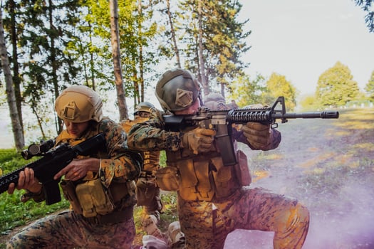 A group of modern warfare soldiers is fighting a war in dangerous remote forest areas. A group of soldiers is fighting on the enemy line with modern weapons. The concept of warfare and military conflicts photo