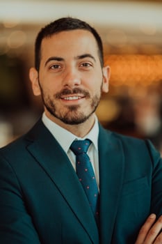 Portrait of a businessman in a suit with his arms crossed in a modern office building photo