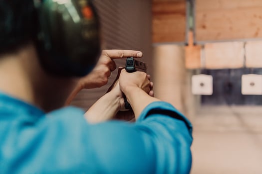 The trainer explaining to the man how to use the gun. Training in the shooting range photo