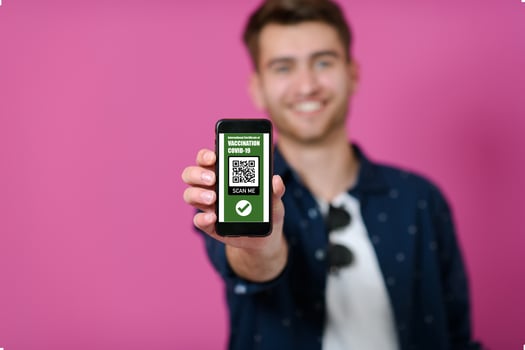 covid passport, a young man shows his code and covid passport on his cell phone photo