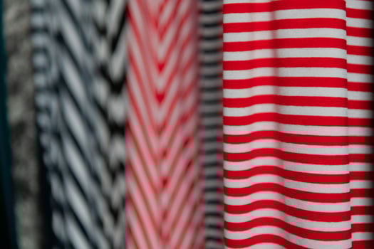 Collection of fashionable fabrics. Samples of different natural fabrics for sewing a fashion collection of clothes. Large selection of fabrics in the store or tailor warehouse. photo