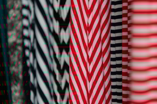 Collection of fashionable fabrics. Samples of different natural fabrics for sewing a fashion collection of clothes. Large selection of fabrics in the store or tailor warehouse. photo