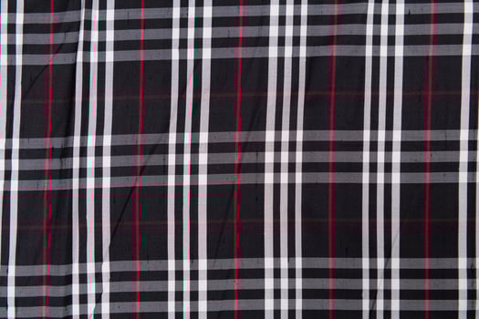 Collection of Scottish fashionable fabrics . Samples of different natural fabrics for sewing a fashion collection of clothes. Large selection of fabrics in the store or tailor warehouse. photo
