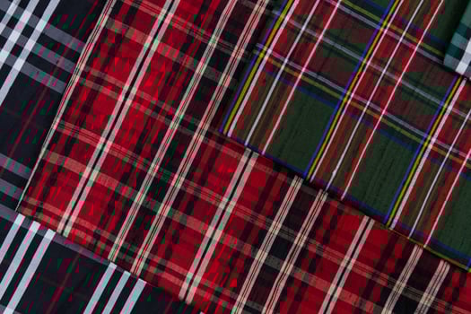 Collection of Scottish fashionable fabrics . Samples of different natural fabrics for sewing a fashion collection of clothes. Large selection of fabrics in the store or tailor warehouse. photo