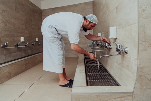 A Muslim performing ablution. Ritual religious cleansing of Muslims before performing prayer. The process of cleansing the body before prayer photo