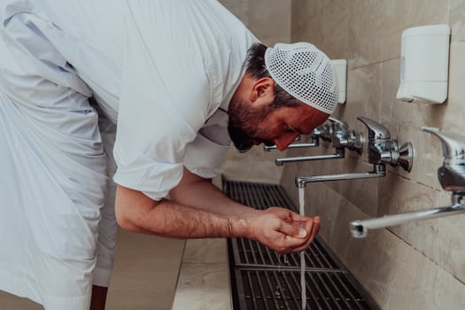A Muslim performing ablution. Ritual religious cleansing of Muslims before performing prayer. The process of cleansing the body before prayer photo