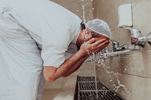 A Muslim performing ablution. Ritual religious cleansing of Muslims before performing prayer. The process of cleansing the body before prayer photo
