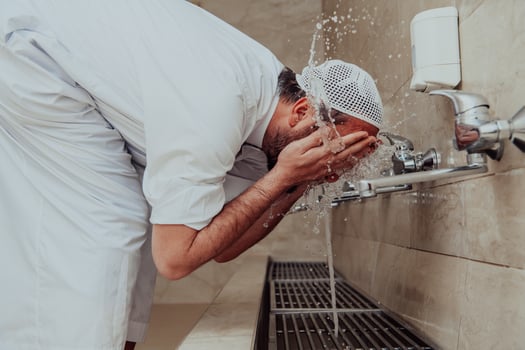 A Muslim performing ablution. Ritual religious cleansing of Muslims before performing prayer. The process of cleansing the body before prayer photo