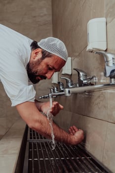 A Muslim performing ablution. Ritual religious cleansing of Muslims before performing prayer. The process of cleansing the body before prayer photo