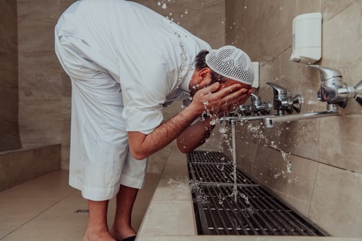 A Muslim performing ablution. Ritual religious cleansing of Muslims before performing prayer. The process of cleansing the body before prayer photo