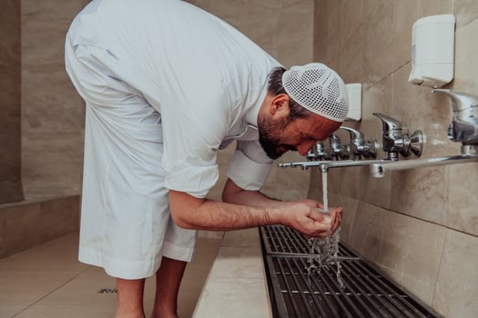 A Muslim performing ablution. Ritual religious cleansing of Muslims before performing prayer. The process of cleansing the body before prayer photo