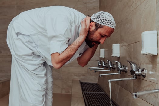 A Muslim performing ablution. Ritual religious cleansing of Muslims before performing prayer. The process of cleansing the body before prayer photo