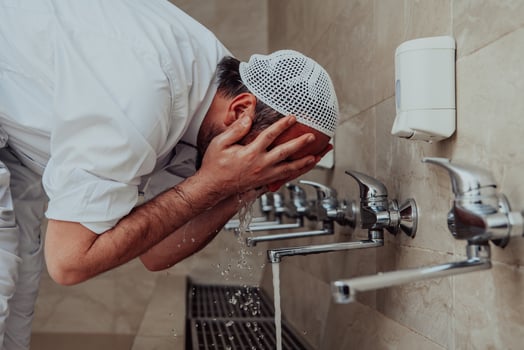 A Muslim performing ablution. Ritual religious cleansing of Muslims before performing prayer. The process of cleansing the body before prayer photo