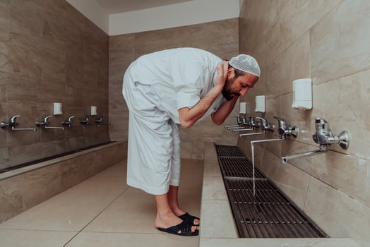A Muslim performing ablution. Ritual religious cleansing of Muslims before performing prayer. The process of cleansing the body before prayer photo