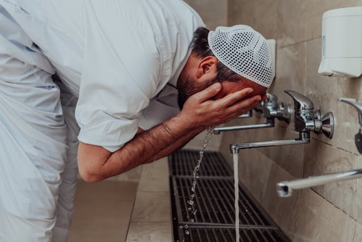 A Muslim performing ablution. Ritual religious cleansing of Muslims before performing prayer. The process of cleansing the body before prayer photo