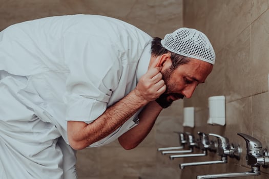 A Muslim performing ablution. Ritual religious cleansing of Muslims before performing prayer. The process of cleansing the body before prayer photo