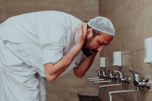 A Muslim performing ablution. Ritual religious cleansing of Muslims before performing prayer. The process of cleansing the body before prayer photo