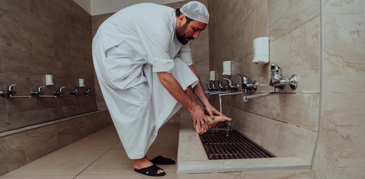 A Muslim performing ablution. Ritual religious cleansing of Muslims before performing prayer. The process of cleansing the body before prayer photo