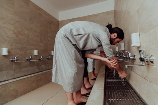 A Muslim performing ablution. Ritual religious cleansing of Muslims before performing prayer. The process of cleansing the body before prayer photo