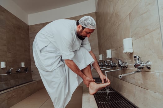 A Muslim performing ablution. Ritual religious cleansing of Muslims before performing prayer. The process of cleansing the body before prayer photo