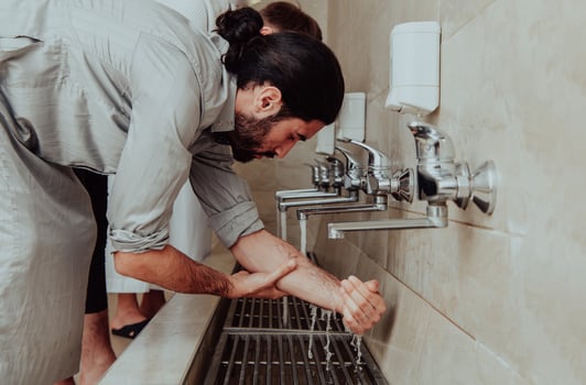 A Muslim performing ablution. Ritual religious cleansing of Muslims before performing prayer. The process of cleansing the body before prayer photo