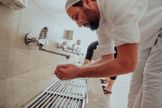A Muslim performing ablution. Ritual religious cleansing of Muslims before performing prayer. The process of cleansing the body before prayer photo