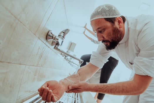 A Muslim performing ablution. Ritual religious cleansing of Muslims before performing prayer. The process of cleansing the body before prayer photo