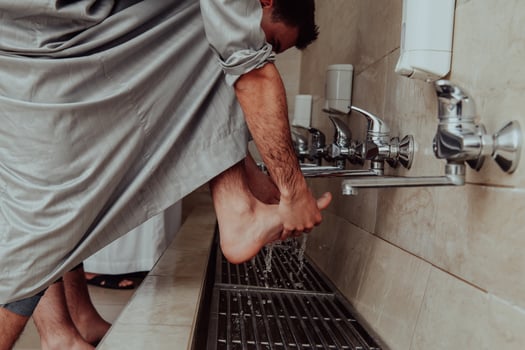 A Muslim performing ablution. Ritual religious cleansing of Muslims before performing prayer. The process of cleansing the body before prayer photo