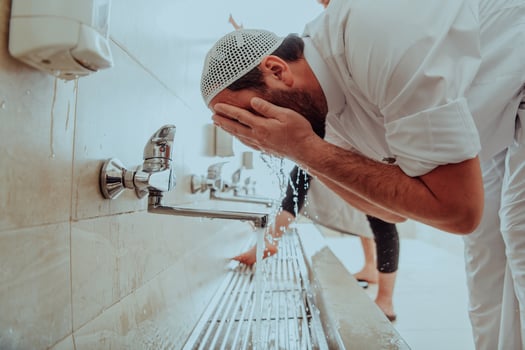 A Muslim performing ablution. Ritual religious cleansing of Muslims before performing prayer. The process of cleansing the body before prayer photo