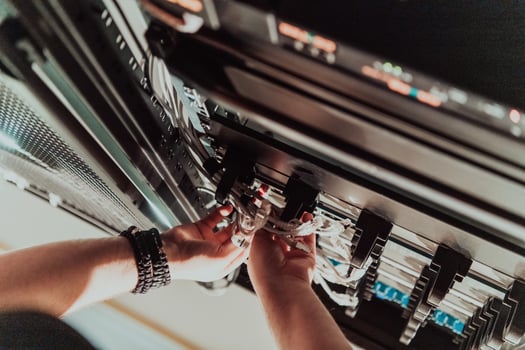 Close up of technician setting up network in server room photo
