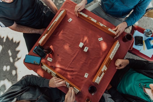 A group of men drink traditional Turkish tea and play a Turkish game called Okey photo