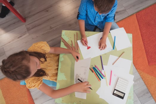 Creative kids sitting in a preschool institution, draw and have fun while they get an education photo