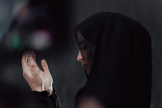 Portrait of young Muslim woman making dua photo