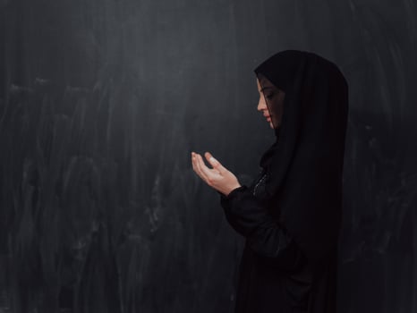 Portrait of young Muslim woman making dua photo