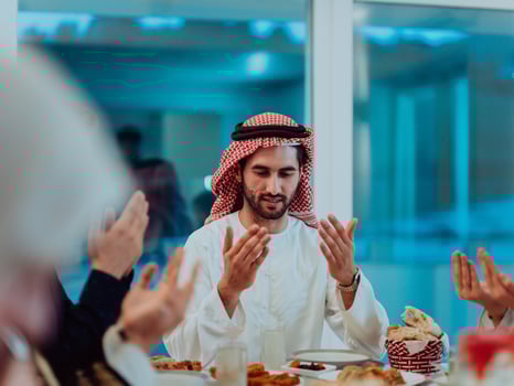 A Muslim family praying together, the Muslim prayer after breaking the fast in the Islamic holy month of Ramadan photo