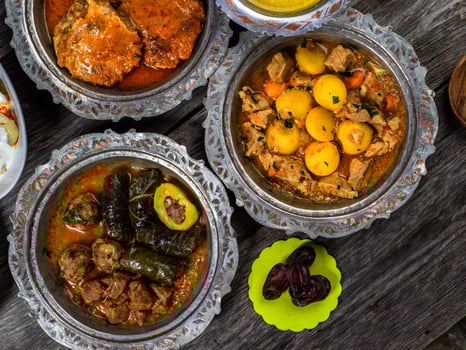 Eid Mubarak Traditional Ramadan Iftar dinner. Assorted tasty food in authentic rustic dishes on wooden blue background. Turkish Bosnian food meat kebab, pita, Sarma, klepe, sogan dolma. photo